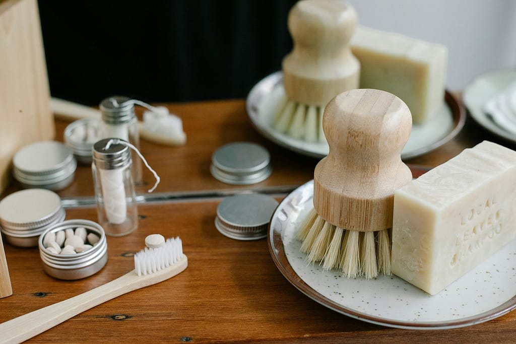 Plastic-free bathroom essentials: bamboo toothbrush, shampoo bars, and reusable containers
